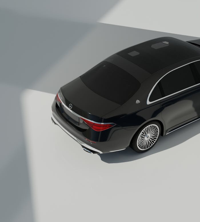 A high-angle view of a black luxury sedan parked indoors, showcasing modern design.